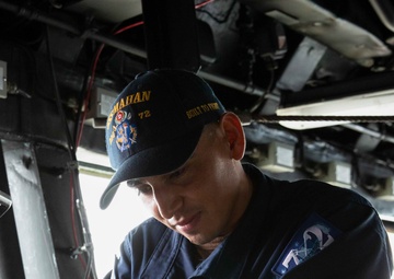 Boatswains Mate of the Watch Polishes Ships Bell