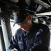 Boatswains Mate of the Watch Polishes Ships Bell