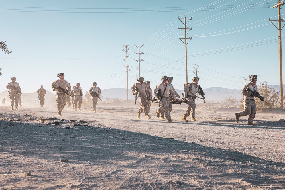 Marines sprint through the finish line during 1st Marine Division Squad Competition