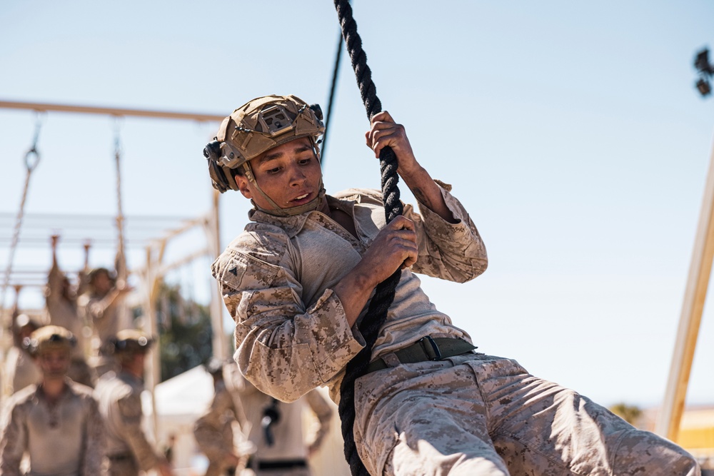Marines sprint through the finish line during 1st Marine Division Squad Competition