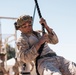 Marines sprint through the finish line during 1st Marine Division Squad Competition