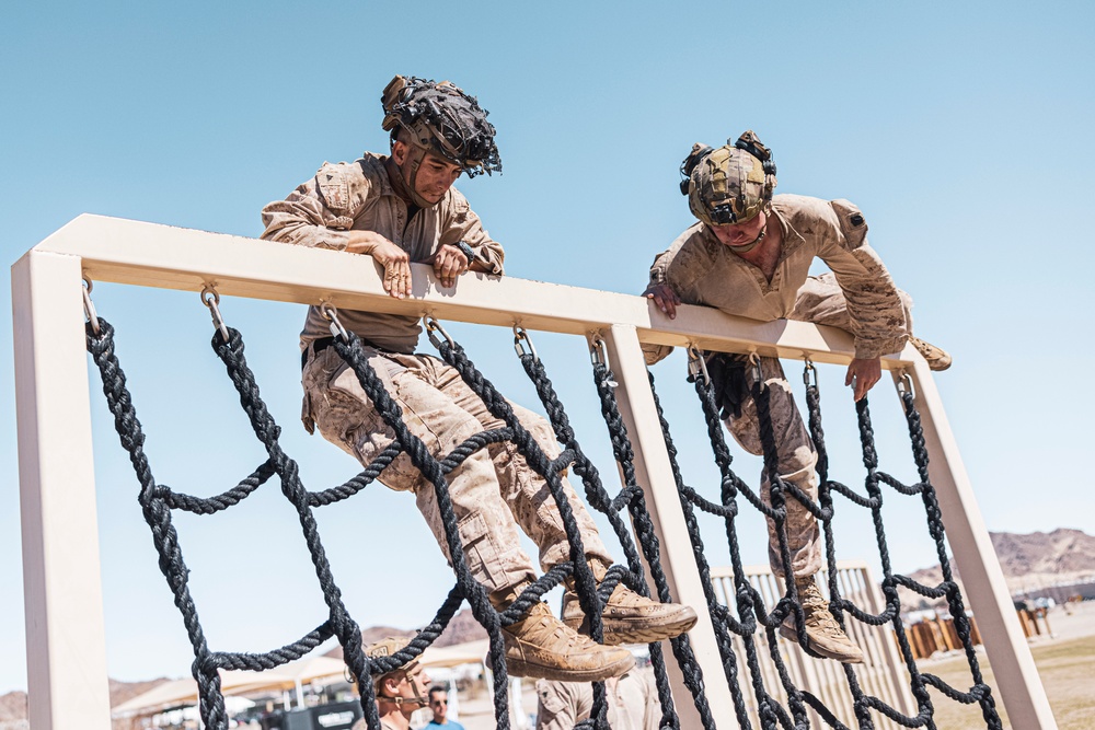 Marines sprint through the finish line during 1st Marine Division Squad Competition