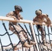 Marines sprint through the finish line during 1st Marine Division Squad Competition