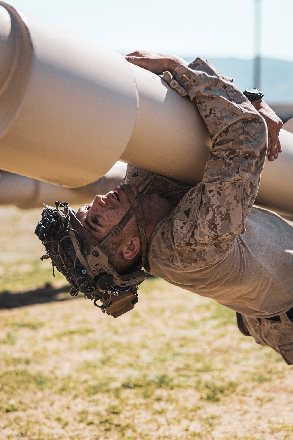 Marines sprint through the finish line during 1st Marine Division Squad Competition
