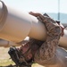 Marines sprint through the finish line during 1st Marine Division Squad Competition