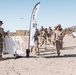 Marines sprint through the finish line during 1st Marine Division Squad Competition