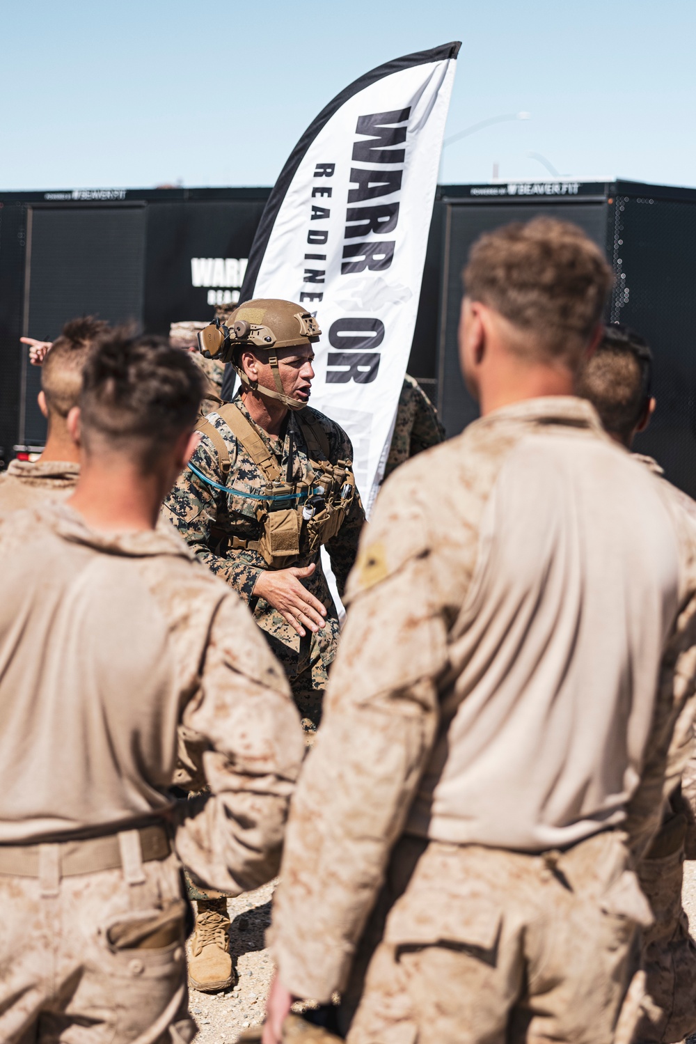 Marines sprint through the finish line during 1st Marine Division Squad Competition