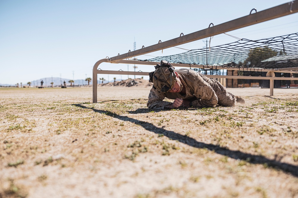 Marines sprint through the finish line during 1st Marine Division Squad Competition