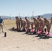 Marines sprint through the finish line during 1st Marine Division Squad Competition