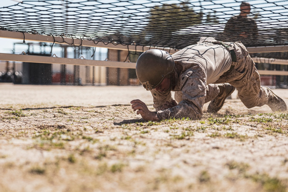 Marines sprint through the finish line during 1st Marine Division Squad Competition