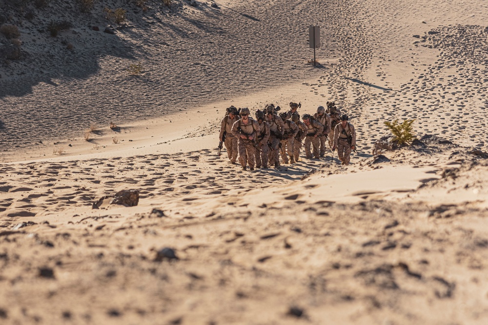 Marines sprint through the finish line during 1st Marine Division Squad Competition