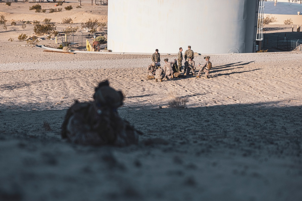 Marines sprint through the finish line during 1st Marine Division Squad Competition