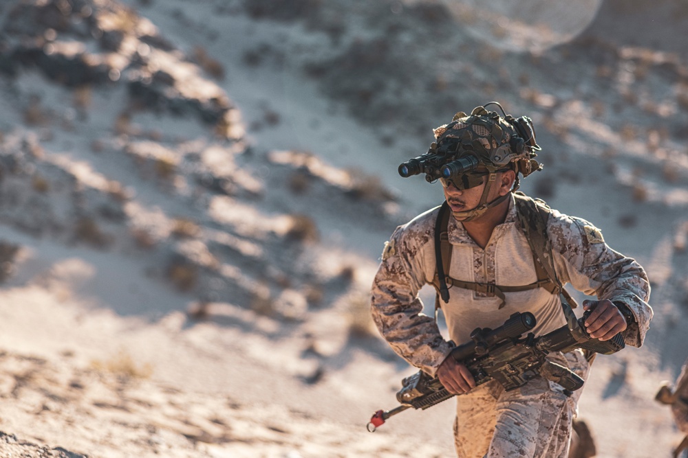Marines sprint through the finish line during 1st Marine Division Squad Competition