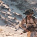 Marines sprint through the finish line during 1st Marine Division Squad Competition
