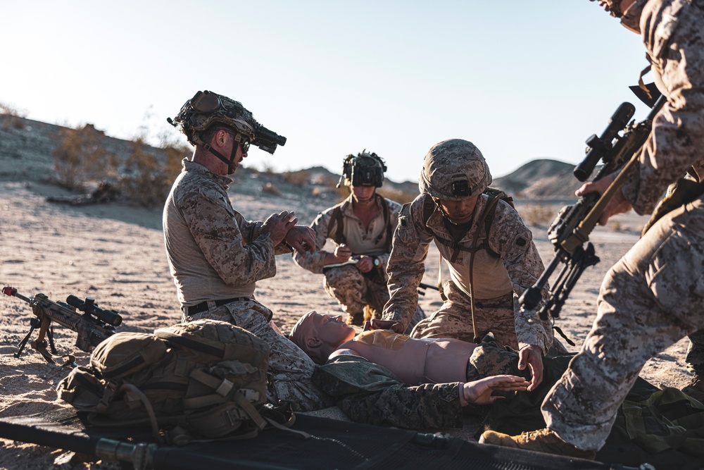 Marines sprint through the finish line during 1st Marine Division Squad Competition