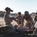 Marines sprint through the finish line during 1st Marine Division Squad Competition