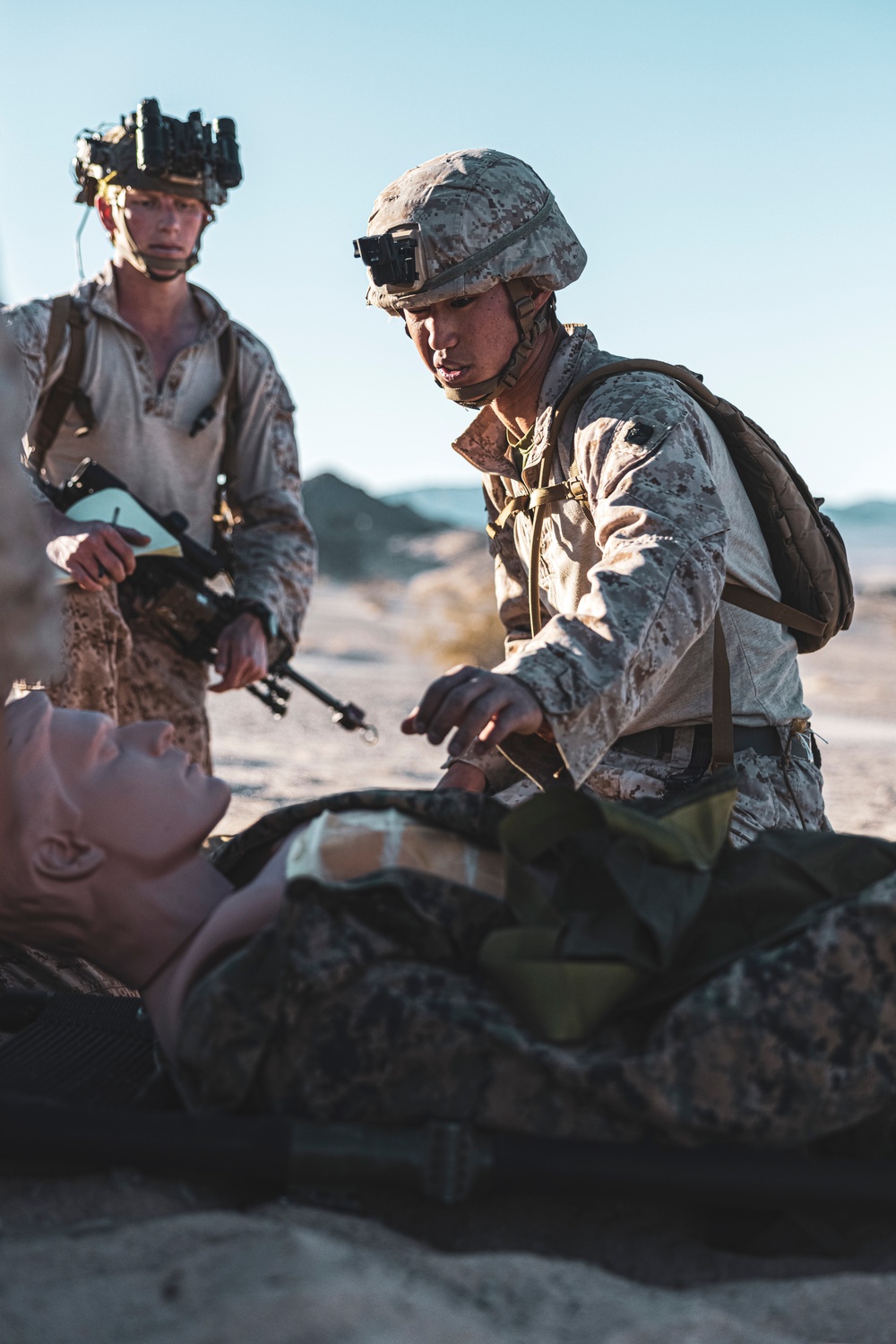 Marines sprint through the finish line during 1st Marine Division Squad Competition
