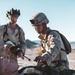Marines sprint through the finish line during 1st Marine Division Squad Competition