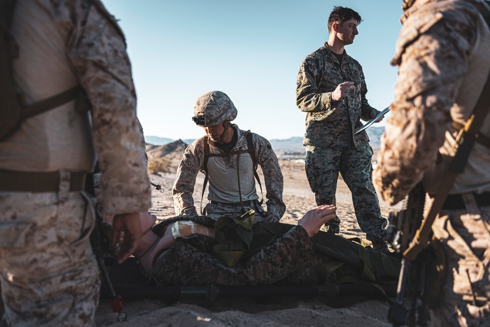Marines sprint through the finish line during 1st Marine Division Squad Competition
