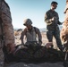 Marines sprint through the finish line during 1st Marine Division Squad Competition