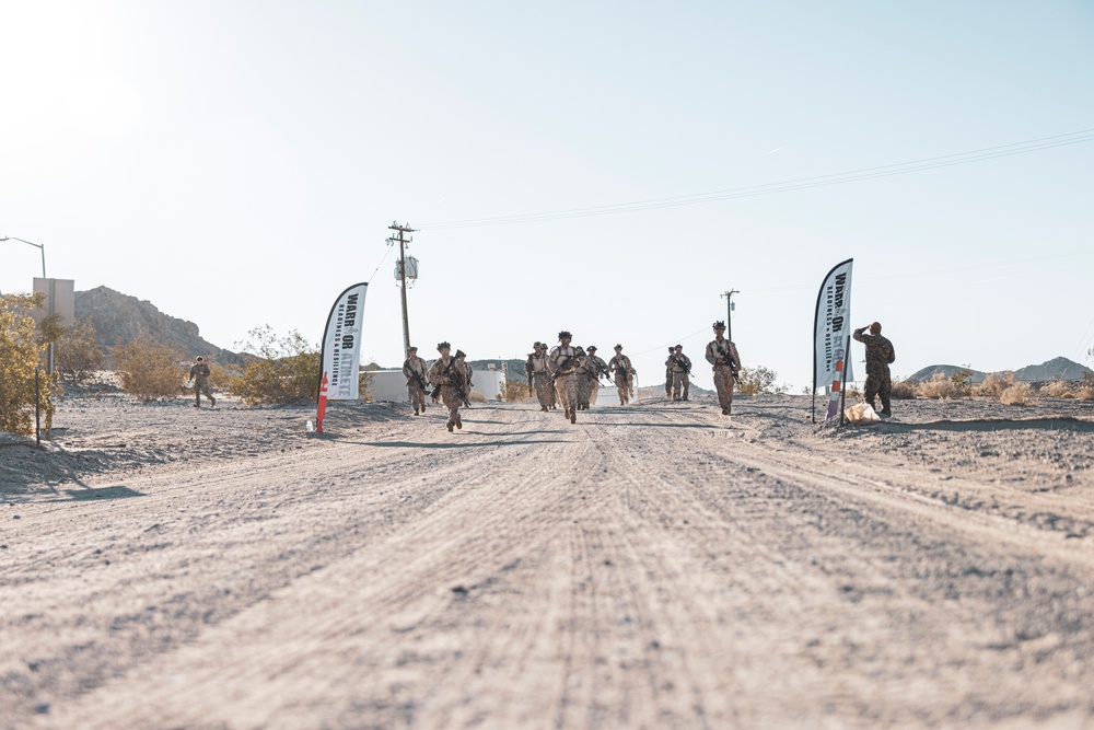 Marines sprint through the finish line during 1st Marine Division Squad Competition
