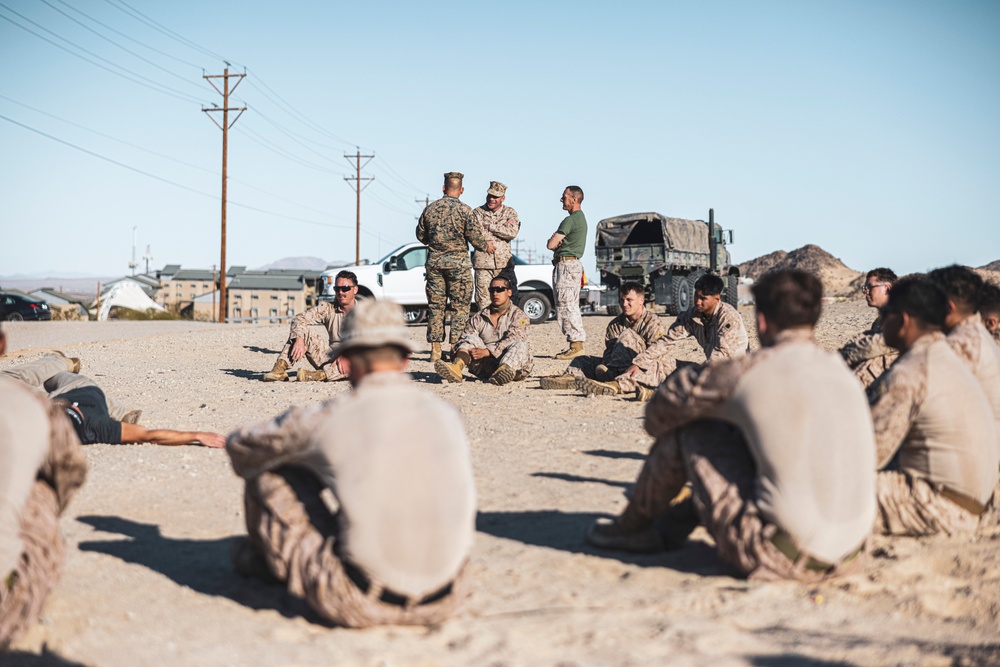Marines sprint through the finish line during 1st Marine Division Squad Competition