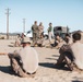 Marines sprint through the finish line during 1st Marine Division Squad Competition