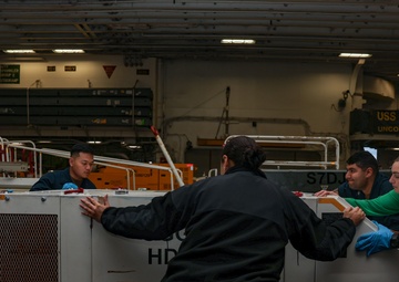 Iwo Jima Sailors move Aircraft Support Equipment For Fueling