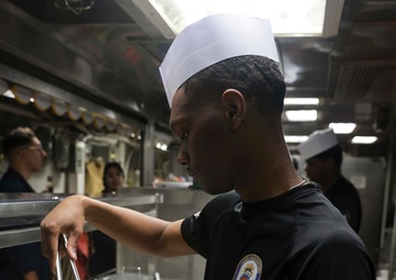 U.S. Navy Sailor prepares breakfast for the crew while in port on Naval Station Rota.