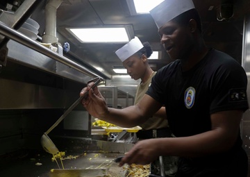 U.S. Navy Sailors prepare breakfast for the crew while in port on Naval Station Rota.