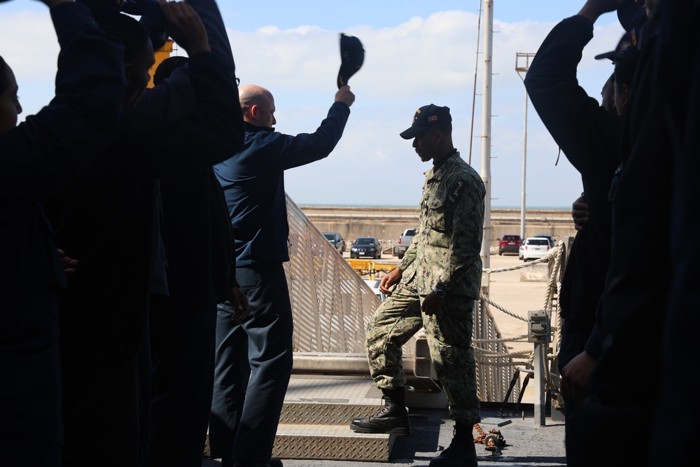 U.S. Navy Sailor is rung off and bid farewell by Executive Officer and fellow shipmates.
