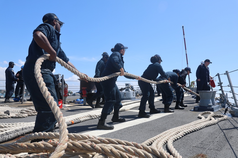 USS Bulkeley DDG 84 deck crew heave in all lines from shore to commence an underway transit aboard the Bulkeley.