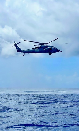 HSC-25 helicopter crew investigates debris west of Guam