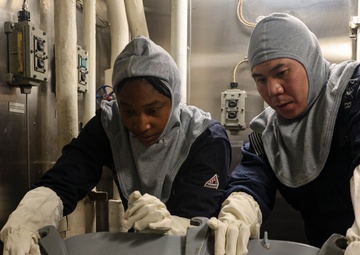 U.S. Navy Sailors lower a water tight hatch and set material condition Zebra.
