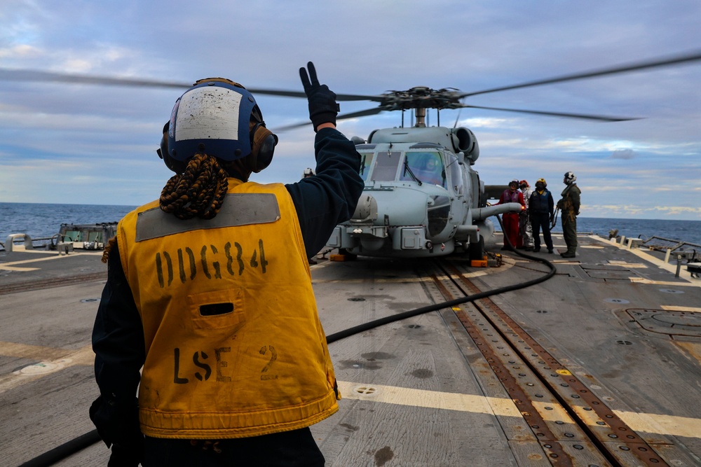 U.S. Navy Sailor signals ground crew.