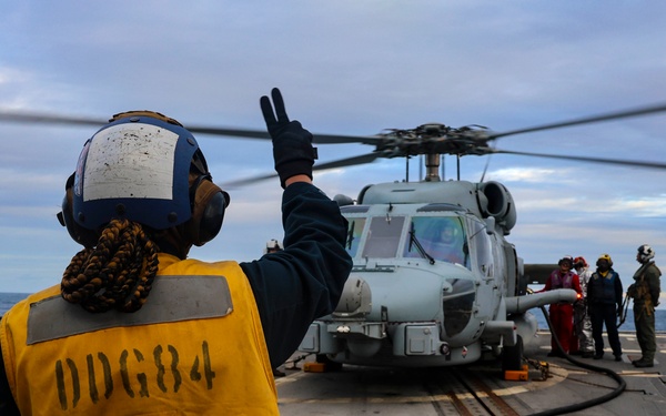 U.S. Navy Sailor signals ground crew.
