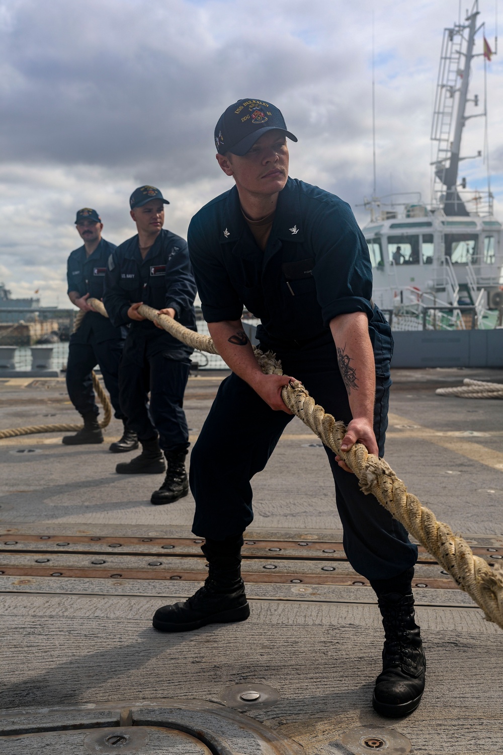 U.S. Navy Sailors heave in mooring lines during a sea-and-anchor detail