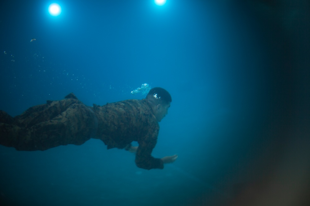 U.S. Marines with MWSS-171 swim in preparation for egress training.