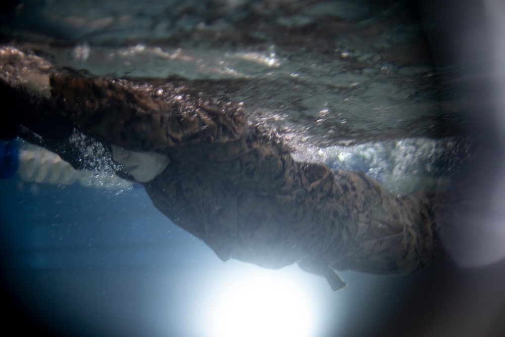 U.S. Marines with MWSS-171 swim in preparation for egress training.