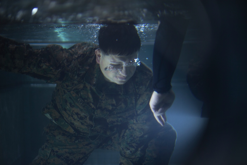 U.S. Marines with MWSS-171 swim in preparation for egress training.