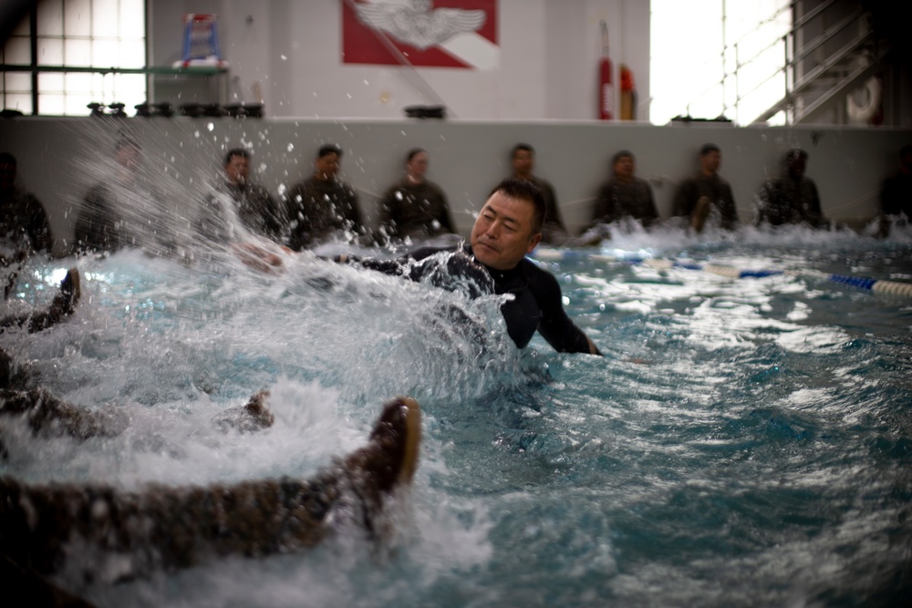 U.S. Marines with MWSS-171 swim in preparation for egress training.