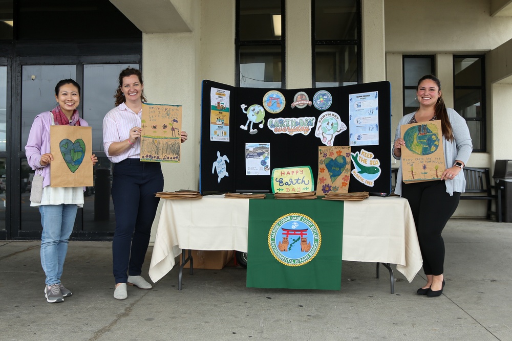 Environmental Affairs Branch members pass out paper bags designed by students from Killin Elementary