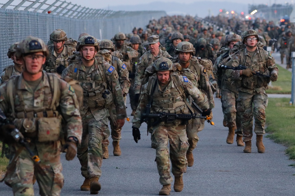 U.S Army Soldiers and ROK army soldiers complete a 12-mile ruck march during Expert Infantry, Soldier, Field Medical Badge testing.