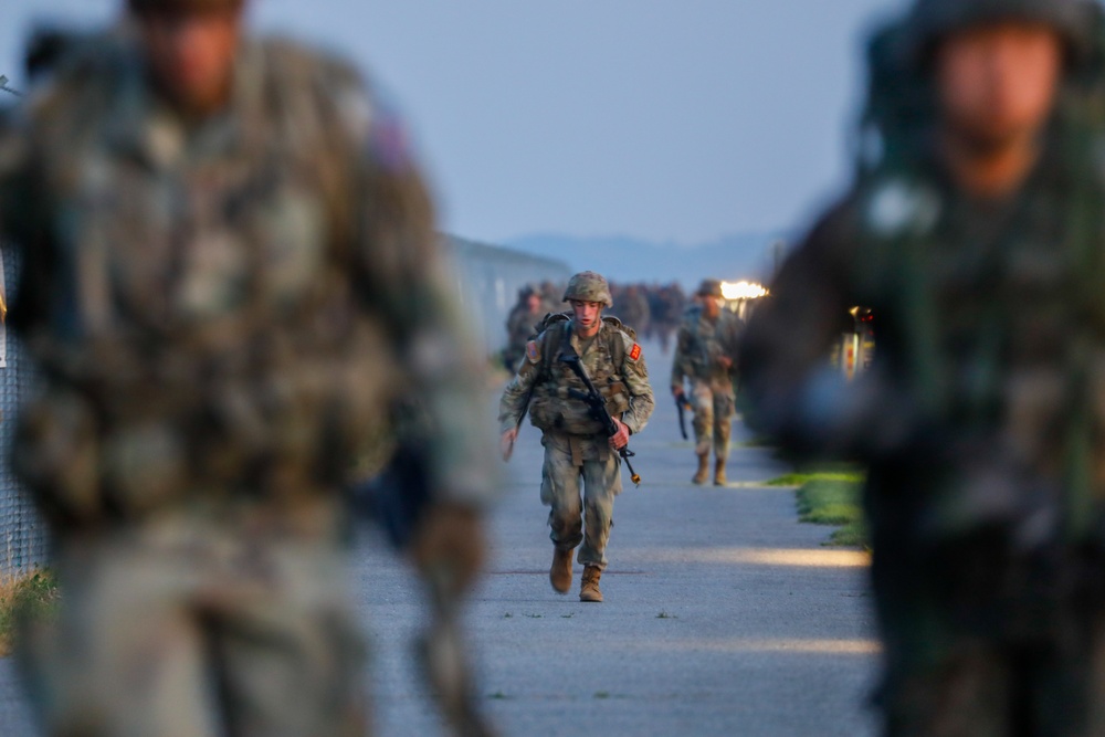 U.S Army Soldiers and ROK army soldiers complete a 12-mile ruck march during Expert Infantry, Soldier, Field Medical Badge testing.