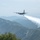 A C-130 (MAFFS 9) from Nevada Air National Guard's 152nd Airlift Wing performs a water drop April 24, 2025, during Modular Airborne Fire Fighting System (MAFFS) Spring Training 2025