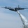 Watering Trees: A C-130 (MAFFS 4) from California Air National Guard's 146th Airlift Wing performs a water drop April 24, 2025, during Modular Airborne Fire Fighting System (MAFFS) Spring Training 2025