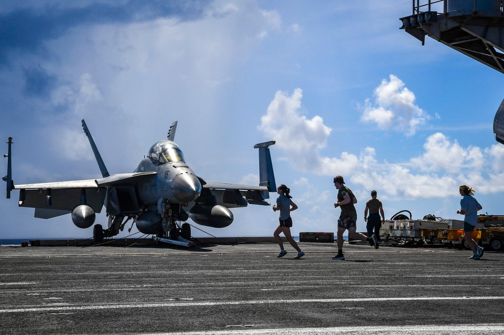 Nimitz Sailors Run On Flight Deck