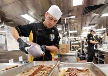 USS Michael Monsoor Sailor Prepares Chow at the Ship's Galley