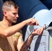 U.S. Navy Sailor installs fasteners on a MH-60R Sea Hawk helicopter