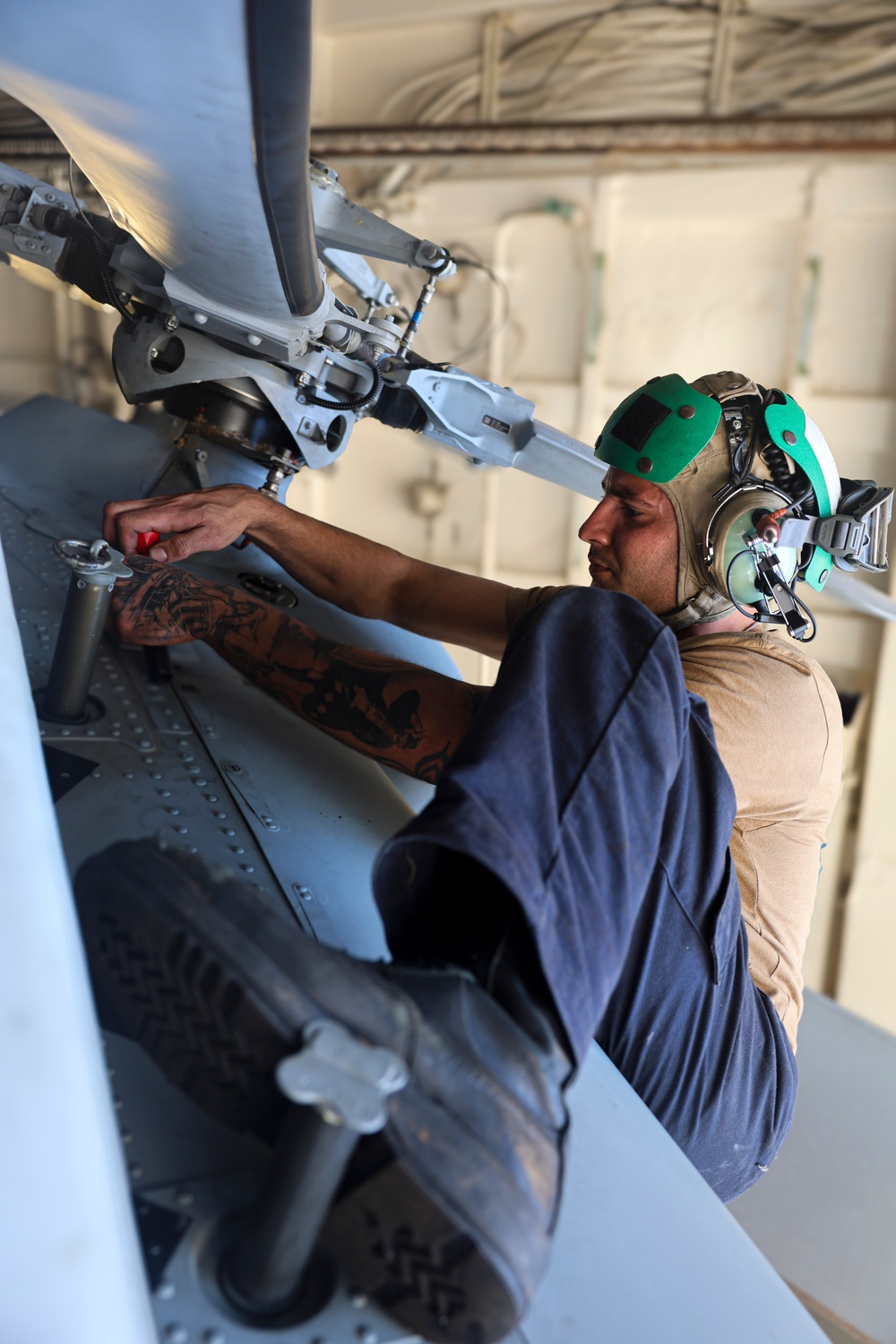 Aviation Structural Mechanic 2nd Class Taylor Gala Rodríguezes conducts pre-flight maintenance